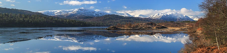 Loch and mountains on a sunny day near Loch Ness at Bearnock 